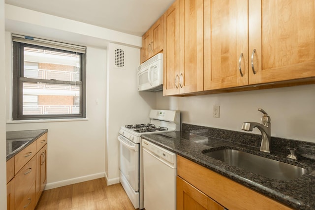 61-25 98th St Unit 11E, Rego Park, NY 11374 - kitchen featuring white appliances, light wood-style flooring, and dark stone countertops