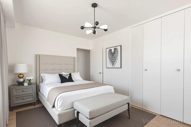 61-25 98th St Unit 11E, Rego Park, NY 11374 - bedroom featuring a chandelier, light wood-type flooring, and a closet