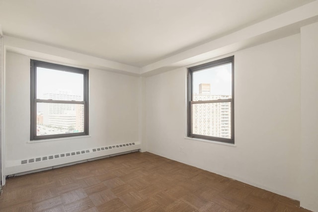 61-25 98th St Unit 11E, Rego Park, NY 11374 - spare room with baseboard heating and plenty of natural light