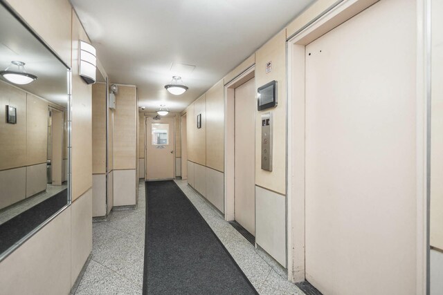 61-25 98th St Unit 11E, Rego Park, NY 11374 - hall featuring elevator and dark aggregate flooring