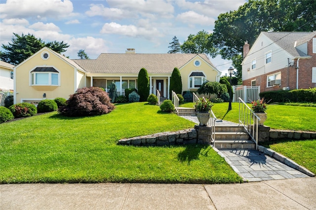 168 Dunwoodie St, Yonkers, NY 10704 - view of front of home with a chimney, a front lawn, and stucco siding
