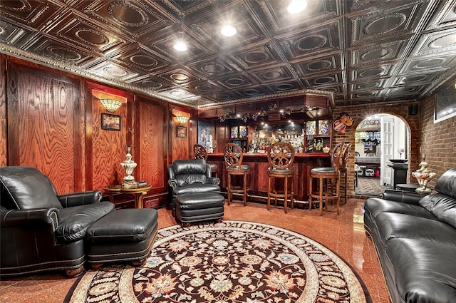 168 Dunwoodie St, Yonkers, NY 10704 - living room featuring a bar, an ornate ceiling, and brick wall