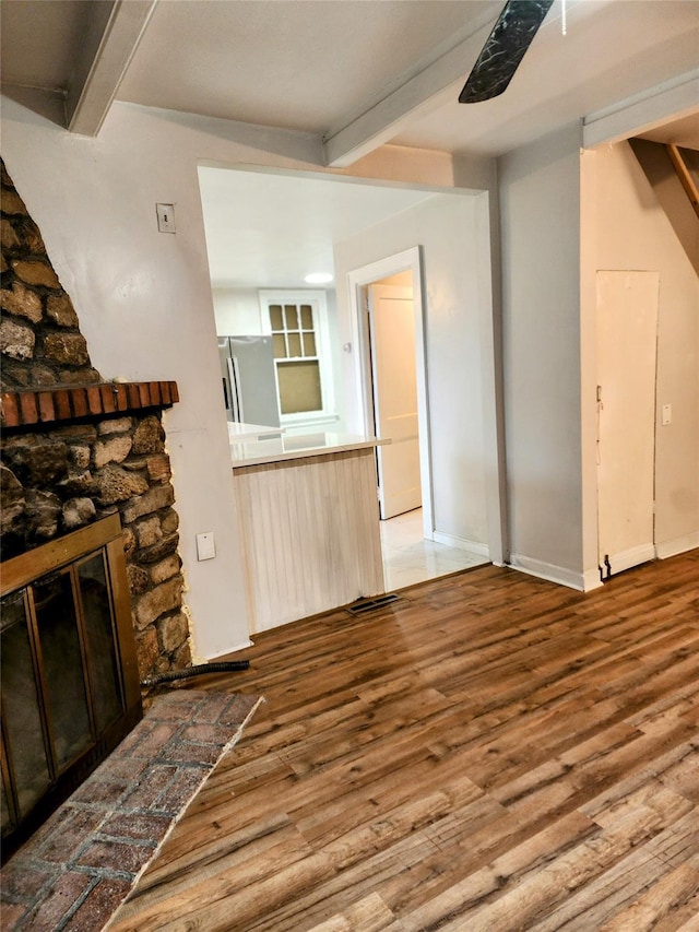13SLake Drive, Patterson, NY 12563 - unfurnished living room featuring beam ceiling, wood finished floors, and a fireplace