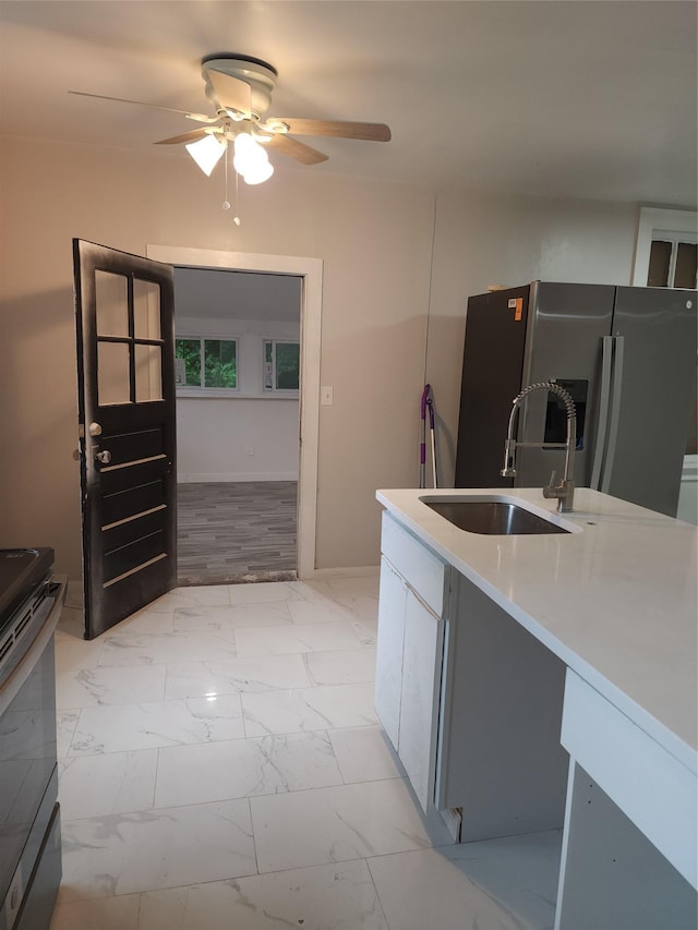 13SLake Drive, Patterson, NY 12563 - kitchen with stainless steel appliances, ceiling fan, light marble finish floors, and light countertops
