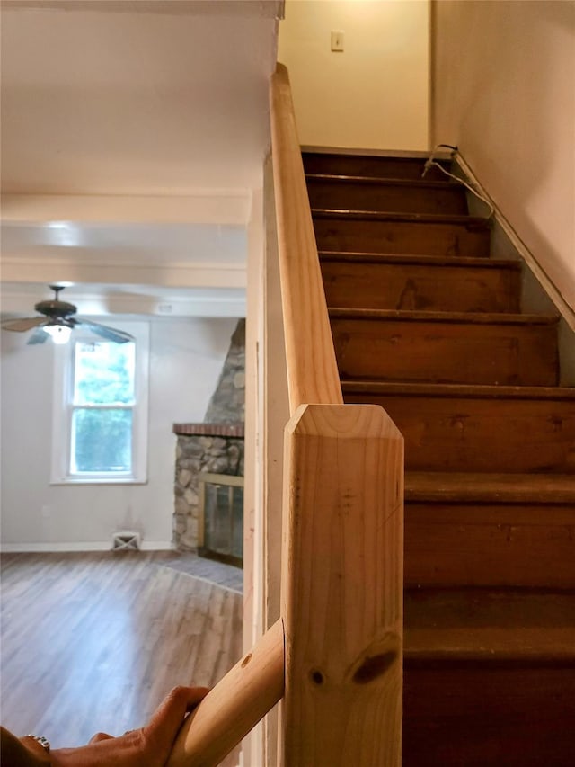 13SLake Drive, Patterson, NY 12563 - stairs featuring wood finished floors, a ceiling fan, and a fireplace