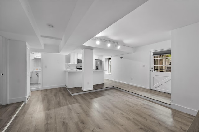1440 Boston Post Unit 8K, Larchmont, NY 10543 - unfurnished living room featuring track lighting and wood finished floors