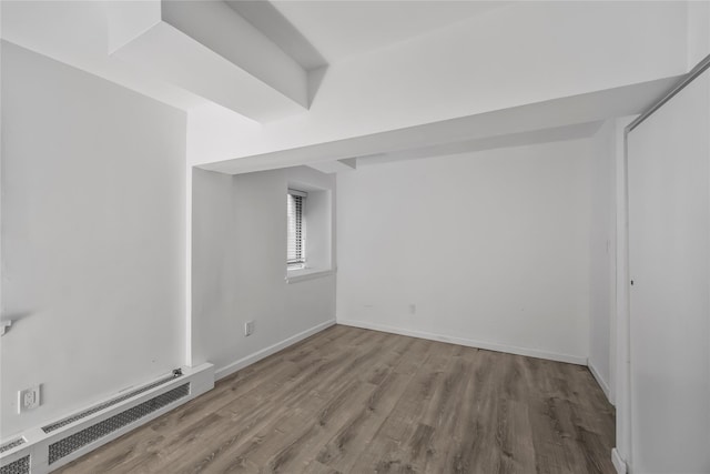 1440 Boston Post Unit 8K, Larchmont, NY 10543 - spare room featuring a baseboard radiator and wood finished floors