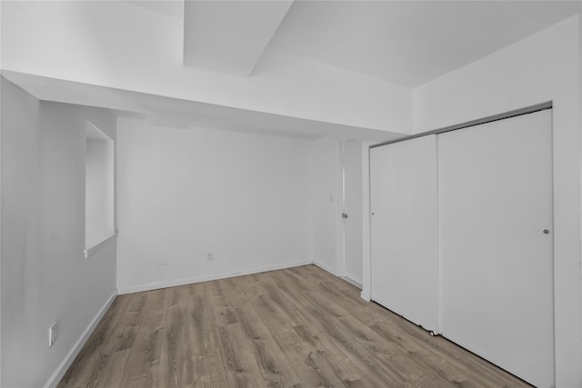 1440 Boston Post Unit 8K, Larchmont, NY 10543 - unfurnished bedroom featuring wood finished floors and a closet