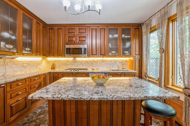 19615 Como Ave, Holliswood, NY 11423 - kitchen with appliances with stainless steel finishes, tasteful backsplash, a chandelier, and a center island