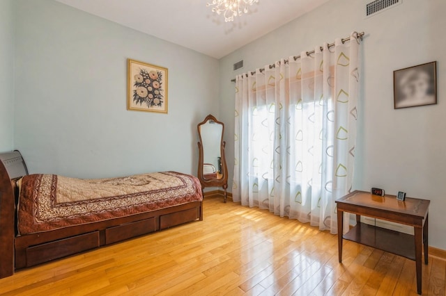 19615 Como Ave, Holliswood, NY 11423 - bedroom with light wood finished floors and a chandelier