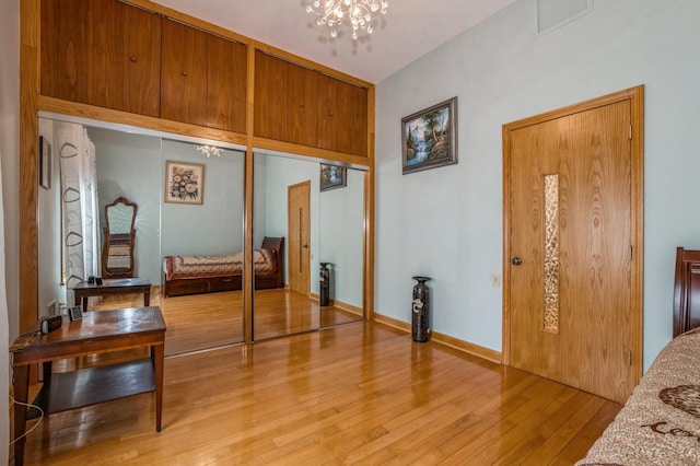 19615 Como Ave, Holliswood, NY 11423 - bedroom featuring light wood-style floors, a chandelier, and a closet