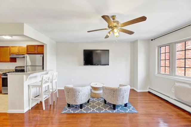 2723 Tilden Ave, Brooklyn, NY 11226 - living area with a baseboard radiator, light wood-style floors, and a ceiling fan