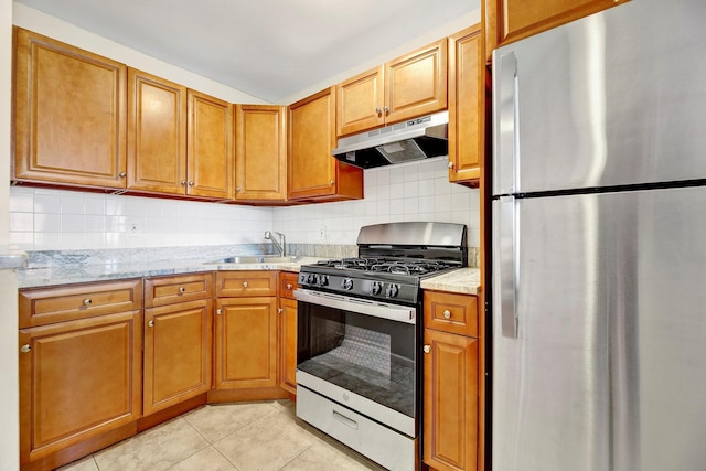 2723 Tilden Ave, Brooklyn, NY 11226 - kitchen featuring stainless steel appliances, under cabinet range hood, light tile patterned flooring, backsplash, and light stone countertops