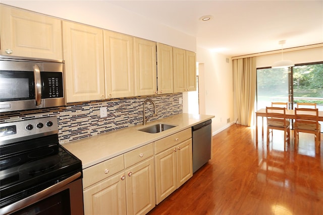 41 Carriage Ct, Jericho, NY 11753 - kitchen featuring stainless steel appliances, tasteful backsplash, light countertops, light wood finished floors, and recessed lighting