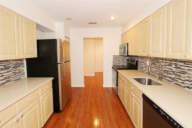 41 Carriage Ct, Jericho, NY 11753 - kitchen featuring appliances with stainless steel finishes, light countertops, decorative backsplash, light wood-style floors, and recessed lighting