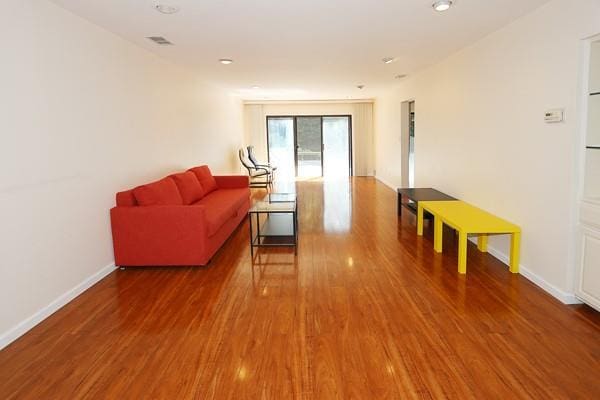 41 Carriage Ct, Jericho, NY 11753 - living room with wood finished floors and baseboards