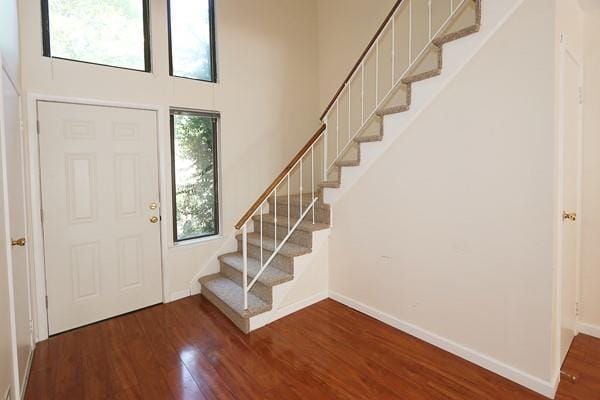 41 Carriage Ct, Jericho, NY 11753 - foyer featuring stairs, wood finished floors, and a high ceiling