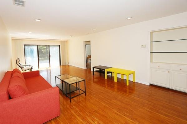 41 Carriage Ct, Jericho, NY 11753 - living room featuring wood finished floors and recessed lighting