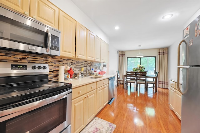 41 Carriage Ct, Jericho, NY 11753 - kitchen featuring appliances with stainless steel finishes, light wood-type flooring, decorative backsplash, light countertops, and recessed lighting