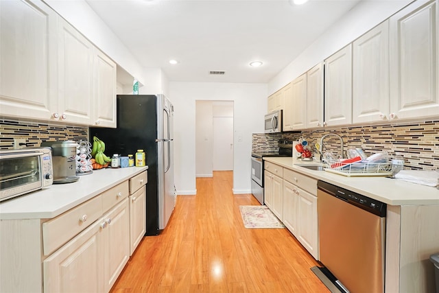 41 Carriage Ct, Jericho, NY 11753 - kitchen featuring stainless steel appliances, backsplash, light countertops, and recessed lighting