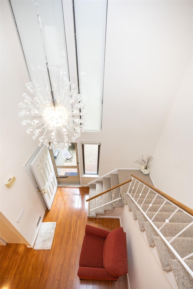 41 Carriage Ct, Jericho, NY 11753 - stairs with a chandelier and wood finished floors