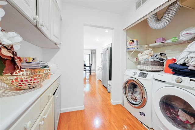 41 Carriage Ct, Jericho, NY 11753 - washroom featuring independent washer and dryer, light wood-style flooring, recessed lighting, and cabinet space