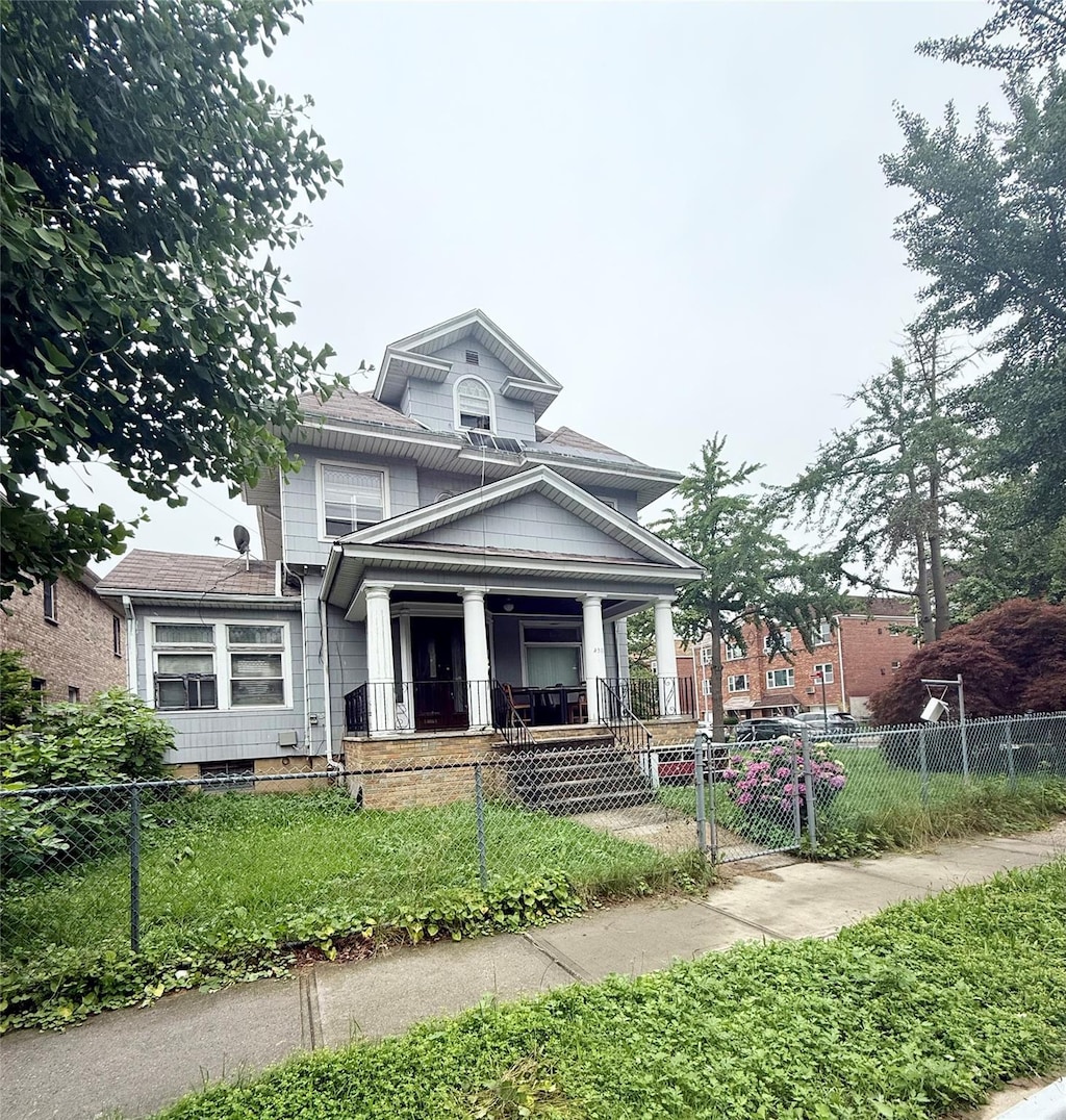 43-04 169th St, Flushing, NY 11358 - traditional style home with a porch, a fenced front yard, and a gate
