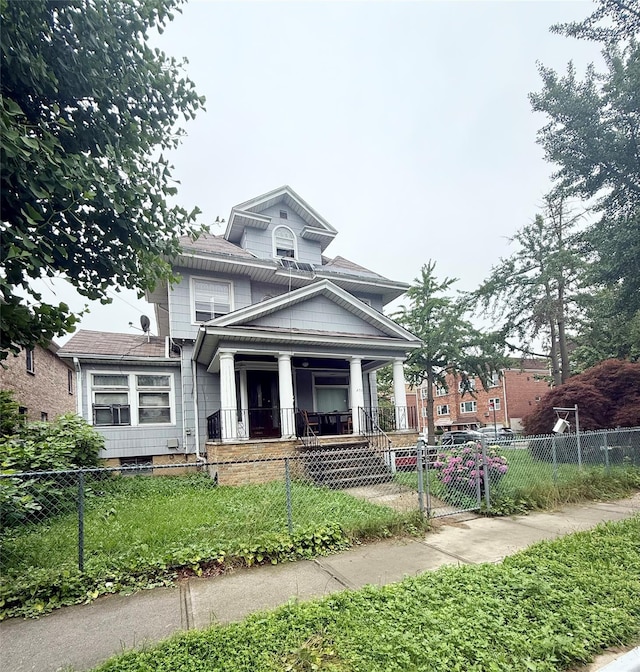 43-04 169th St, Flushing, NY 11358 - traditional style home with a porch, a fenced front yard, and a gate