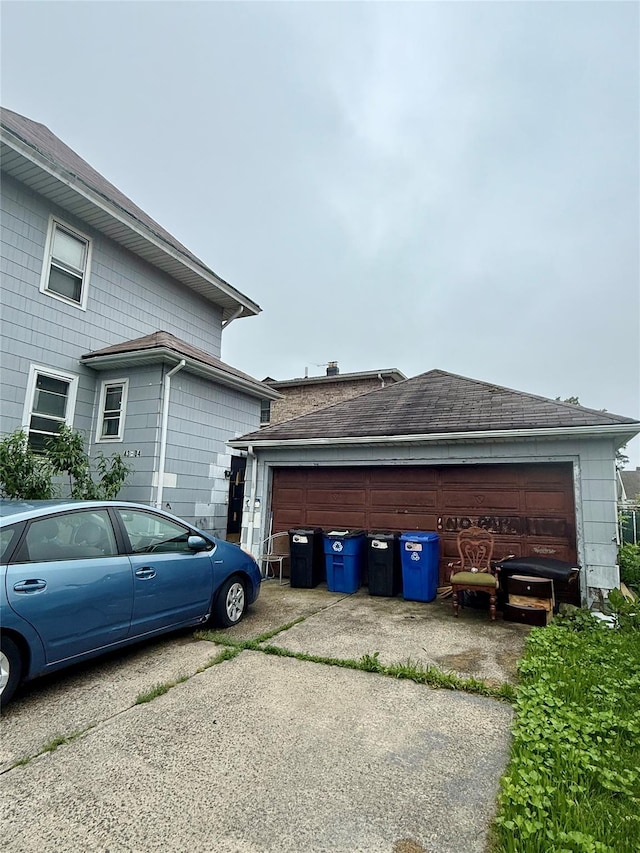 43-04 169th St, Flushing, NY 11358 - view of side of property with an outdoor structure, a garage, and a shingled roof