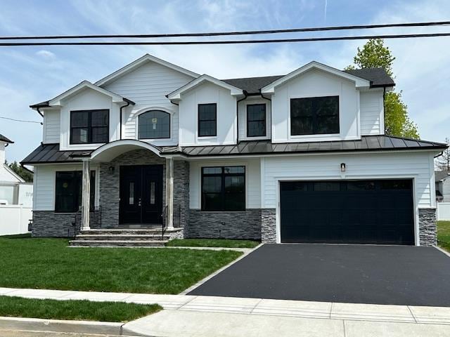 15 Cedar Dr, Old Bethpage, NY 11804 - view of front of property featuring stone siding, a standing seam roof, and driveway