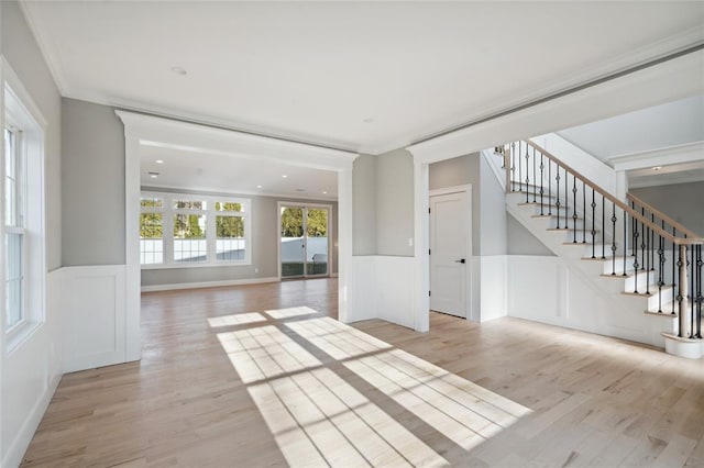 15 Cedar Dr, Old Bethpage, NY 11804 - unfurnished room featuring stairway, light wood finished floors, a wainscoted wall, and a decorative wall