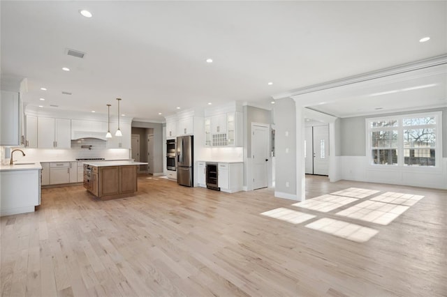 15 Cedar Dr, Old Bethpage, NY 11804 - kitchen with stainless steel fridge with ice dispenser, open floor plan, tasteful backsplash, wine cooler, and a kitchen island