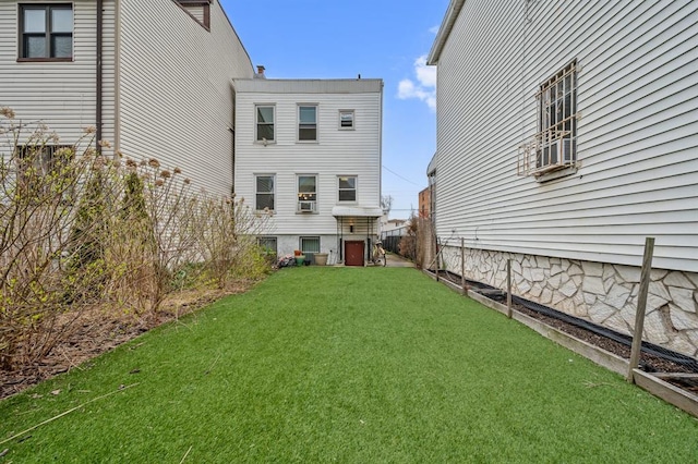 338 Hendrix St, Brooklyn, NY 11207 - rear view of house featuring a yard