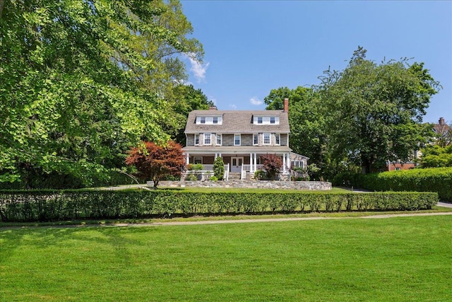 20 The Blvd, New Rochelle, NY 10801 - rear view of house featuring a yard, a chimney, and covered porch