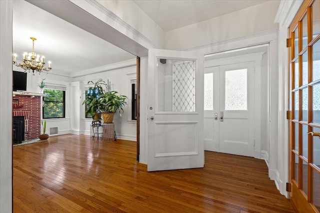 20 The Blvd, New Rochelle, NY 10801 - entryway with a chandelier, hardwood / wood-style flooring, a fireplace, and french doors