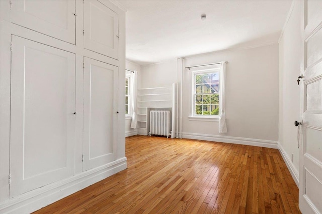 20 The Blvd, New Rochelle, NY 10801 - unfurnished bedroom with radiator, light wood-style flooring, and crown molding