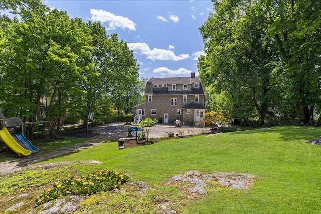 20 The Blvd, New Rochelle, NY 10801 - view of grassy yard featuring a playground and a patio