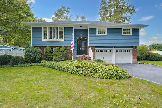 15 Eastover Dr, East Northport, NY 11731 - split foyer home featuring an attached garage, asphalt driveway, and brick siding