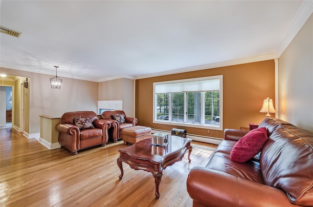 15 Eastover Dr, East Northport, NY 11731 - living area with a baseboard radiator, light wood-type flooring, and ornamental molding