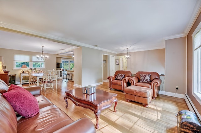 15 Eastover Dr, East Northport, NY 11731 - living area with a chandelier, light wood-style flooring, baseboard heating, and ornamental molding