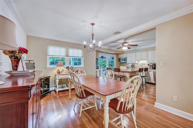 15 Eastover Dr, East Northport, NY 11731 - dining area with crown molding, light wood-style flooring, a ceiling fan, a chandelier, and a baseboard radiator