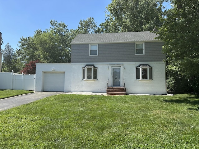 4 Wilwade Rd, Great Neck, NY 11020 - colonial inspired home with driveway, brick siding, a garage, and entry steps