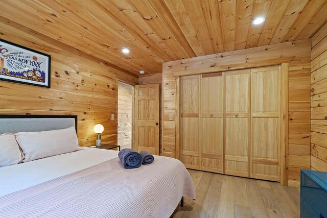 892 Durham Rd, Gilboa, NY 12076 - bedroom featuring wooden walls, recessed lighting, hardwood / wood-style floors, wood ceiling, and a closet
