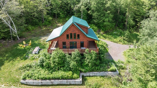 892 Durham Rd, Gilboa, NY 12076 - exterior space with a view of trees, log exterior, a deck, and dirt driveway