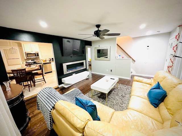 21 Pennwood Dr, Mastic Beach, NY 11951 - living area featuring a ceiling fan, wood finished floors, stairs, recessed lighting, and a fireplace
