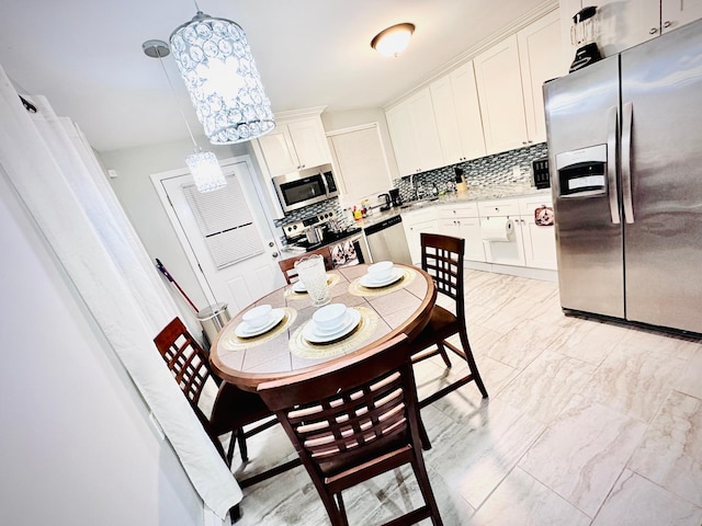 21 Pennwood Dr, Mastic Beach, NY 11951 - kitchen featuring appliances with stainless steel finishes, backsplash, light countertops, and white cabinetry