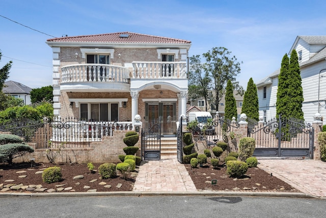 38-16 220th St, Bayside, NY 11361 - view of front facade featuring a balcony, a gate, and a fenced front yard