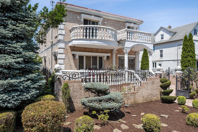 38-16 220th St, Bayside, NY 11361 - view of front of house with a balcony and brick siding