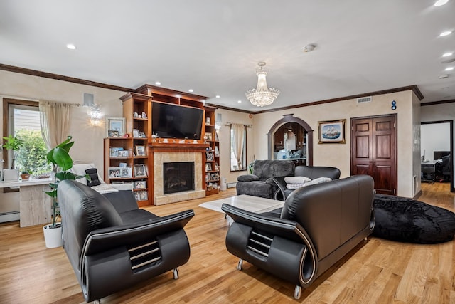 38-16 220th St, Bayside, NY 11361 - living area featuring crown molding, a chandelier, recessed lighting, a fireplace with raised hearth, and light wood-style floors