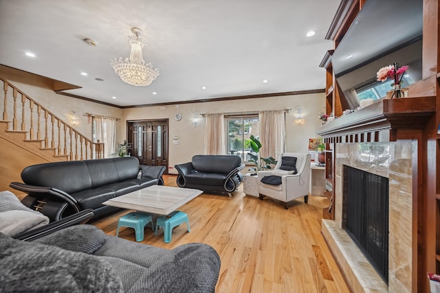 38-16 220th St, Bayside, NY 11361 - living area featuring a high end fireplace, ornamental molding, a chandelier, light wood finished floors, and stairs